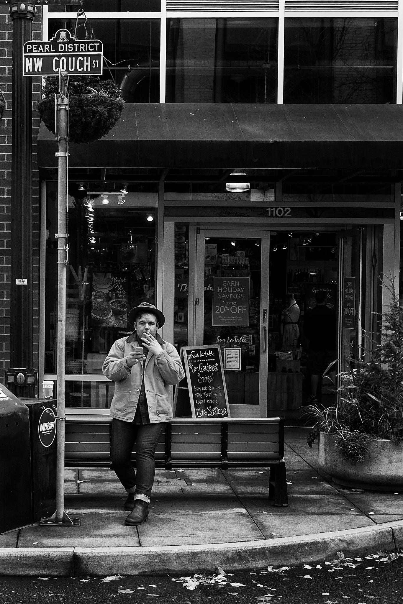 Candid street portrait of a contemplative smoker on Couch Street in the Pearl District of Portland Oregon