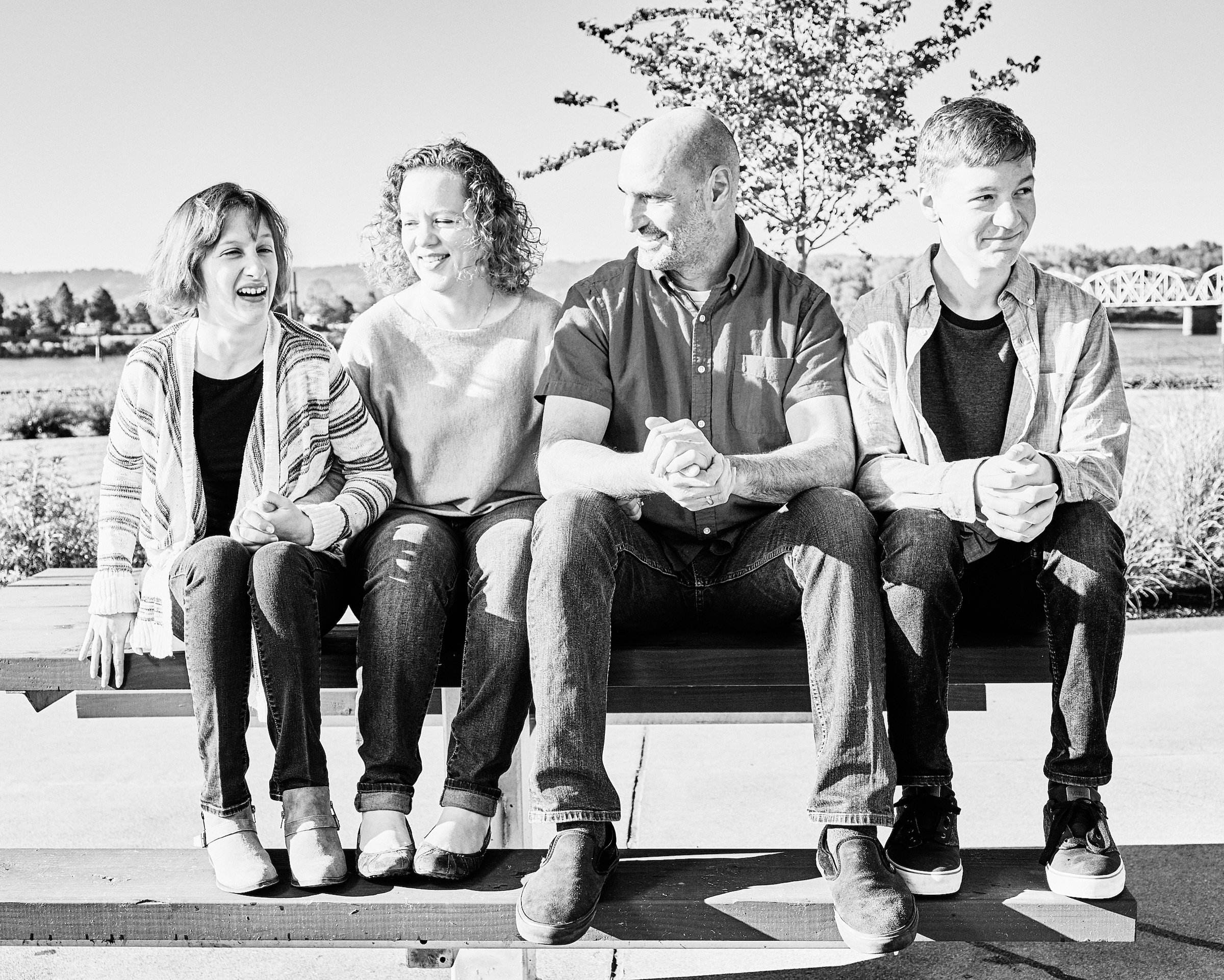 Intimate and tender family portrait capturing parents and children in natural light