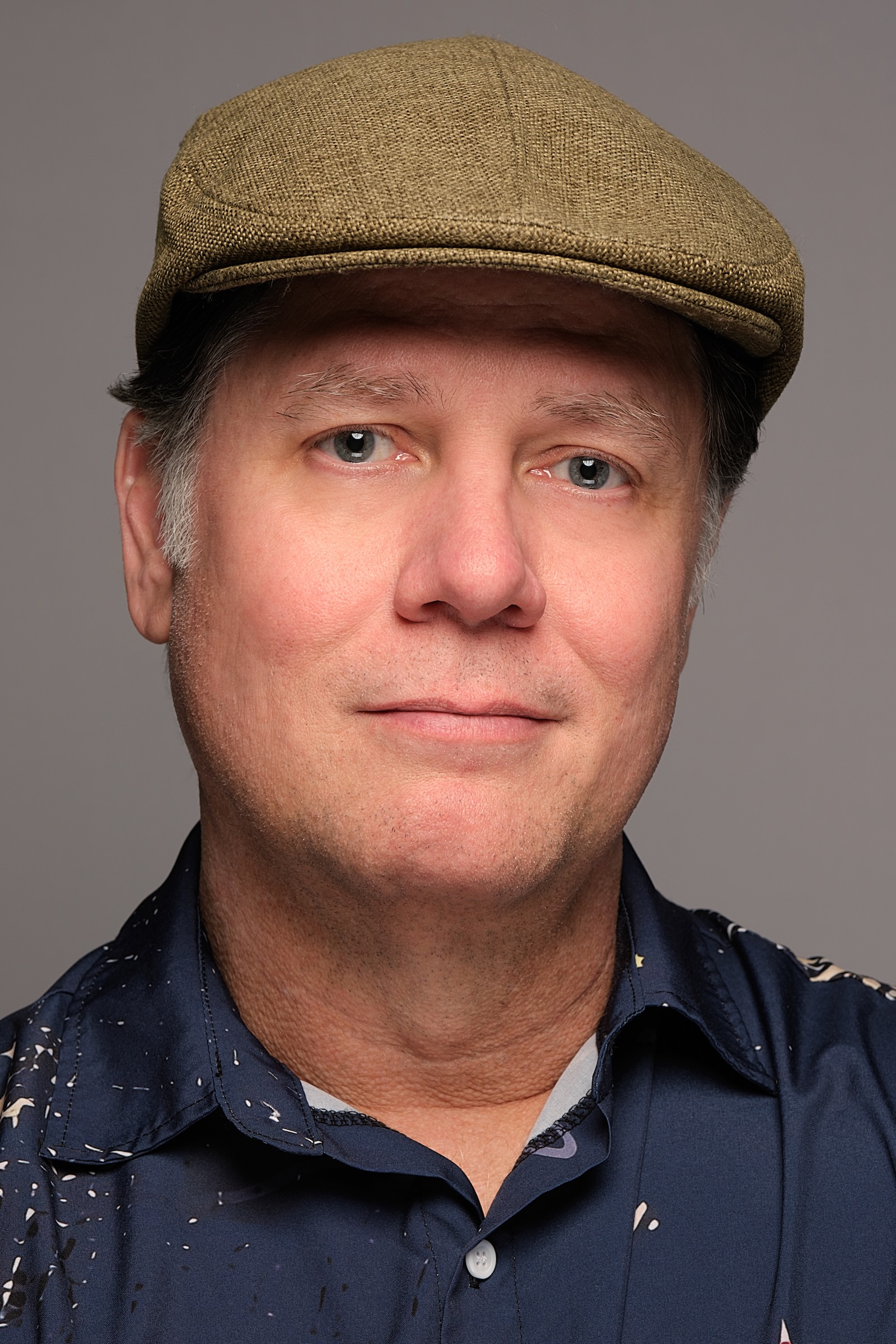 Portrait of a man in a hat illuminated by warm amber ambient lighting in Portland Oregon