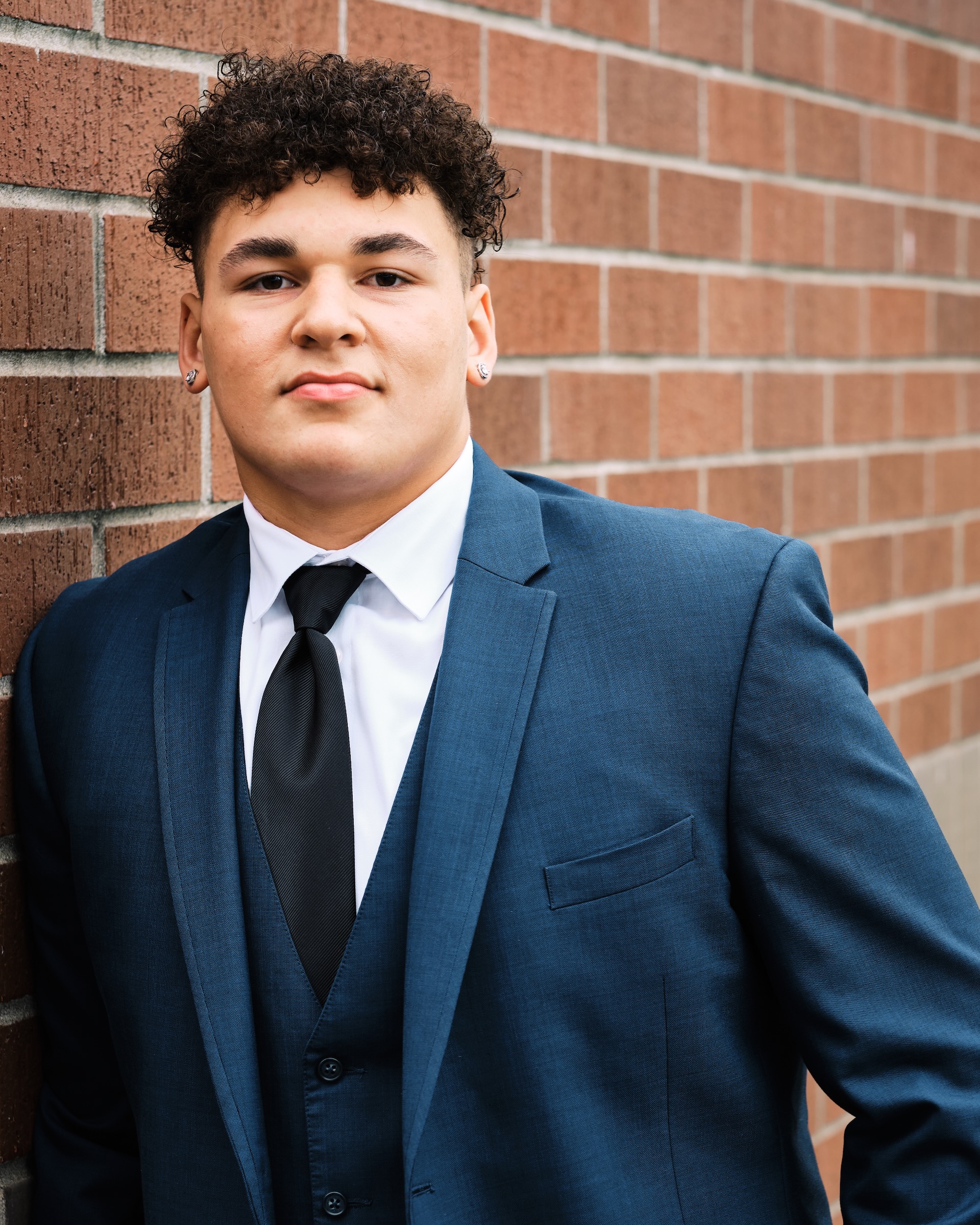 High school senior football player in a tailored suit in Vancouver Washington